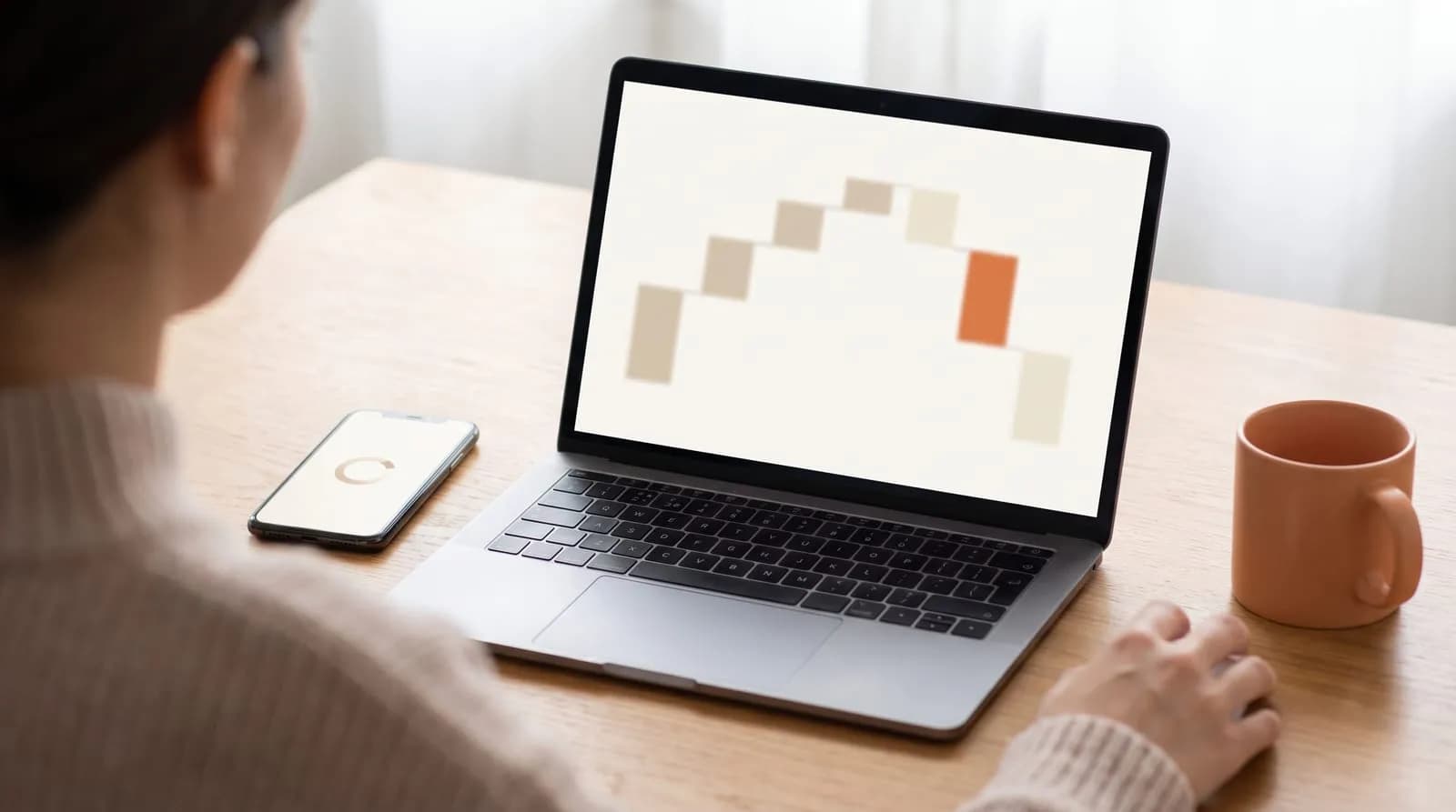 Developer reviewing a website performance waterfall chart beside a loading page on a phone